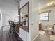 Neutral colored bathroom with tiled floor featuring an adjacent view of the living room with bar stools at 11114 Lake Eustis Dr, Leesburg, FL 34788