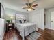 Cozy bedroom with a ceiling fan, wood flooring, and a comfortable queen bed near a closet at 11114 Lake Eustis Dr, Leesburg, FL 34788