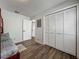 Bedroom with wood floors and closet. An open door provides view of additional rooms at 11114 Lake Eustis Dr, Leesburg, FL 34788