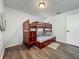 Bedroom features wood-look floors, a window with blinds, and a built-in bunk bed at 11114 Lake Eustis Dr, Leesburg, FL 34788