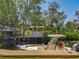 A boat sits moored to a wooden dock in a picturesque waterway setting at 11114 Lake Eustis Dr, Leesburg, FL 34788