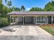 Charming single-story home with a well-manicured lawn, covered parking, and a welcoming front entrance at 11114 Lake Eustis Dr, Leesburg, FL 34788