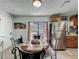 Eat in kitchen features stainless steel refrigerator and sliding glass door to back patio at 11114 Lake Eustis Dr, Leesburg, FL 34788
