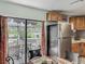 Eat in kitchen features stainless steel refrigerator and sliding glass door to back patio at 11114 Lake Eustis Dr, Leesburg, FL 34788