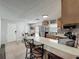 Open concept kitchen with counter seating, stainless steel appliances and tile backsplash at 11114 Lake Eustis Dr, Leesburg, FL 34788