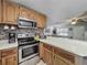 Galley kitchen with stainless steel appliances, tile backsplash and oak cabinets at 11114 Lake Eustis Dr, Leesburg, FL 34788