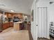 Open concept kitchen with breakfast bar and wood cabinets at 11114 Lake Eustis Dr, Leesburg, FL 34788