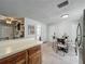 Bright eat-in kitchen with tiled floor, white walls, and breakfast nook near an appliance filled countertop at 11114 Lake Eustis Dr, Leesburg, FL 34788