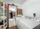 Well-equipped laundry space adjacent to the kitchen area with storage and appliances at 11114 Lake Eustis Dr, Leesburg, FL 34788