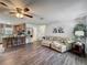This spacious living room features vinyl plank flooring, a built-in shelving unit, and open access to the kitchen at 11114 Lake Eustis Dr, Leesburg, FL 34788