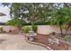 A lush backyard with a stone fountain, mature trees, and a brick paved patio, provides a serene outdoor space at 1121 Ricardo Ave, The Villages, FL 32159
