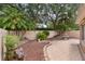 Lush backyard featuring a fountain, mature palm trees, and a brick paved patio offers a relaxing outdoor retreat at 1121 Ricardo Ave, The Villages, FL 32159
