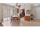 Light-filled dining area featuring sliding doors and table with seating for four adjacent to kitchen at 1121 Ricardo Ave, The Villages, FL 32159