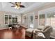 Bright dining room featuring wood floors, a glass-topped table, and windows with shutter blinds offering abundant natural light at 1121 Ricardo Ave, The Villages, FL 32159