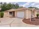 Charming single-story home with a manicured lawn and a two-car garage at 1121 Ricardo Ave, The Villages, FL 32159
