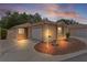 Charming single-story home with a manicured lawn and a two-car garage during dusk at 1121 Ricardo Ave, The Villages, FL 32159