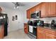 This well-lit kitchen features warm wood cabinets, dark countertops, and modern appliances at 1121 Ricardo Ave, The Villages, FL 32159