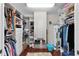 A well-organized walk-in closet with custom shelving, hanging racks, and built-in drawers provides ample storage space at 1121 Ricardo Ave, The Villages, FL 32159