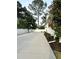 Long concrete driveway with basketball hoop and a beautiful fenced in yard with professional landscaping at 121 N Summit Ave, Lake Helen, FL 32744