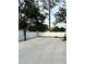 Outdoor basketball court with adjustable hoop and white fence creating a private area for sports and recreation at 121 N Summit Ave, Lake Helen, FL 32744