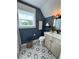 Bathroom featuring blue walls, decorative tile floors, and natural light at 121 N Summit Ave, Lake Helen, FL 32744