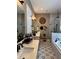 Stylish bathroom with double sinks, patterned tile floor, and a glass-enclosed shower at 121 N Summit Ave, Lake Helen, FL 32744