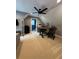 Upstairs bonus room featuring a ceiling fan, desk, and view to an en suite bathroom at 121 N Summit Ave, Lake Helen, FL 32744
