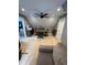 Upstairs bonus room featuring a ceiling fan, sofa, desk, and stairway at 121 N Summit Ave, Lake Helen, FL 32744
