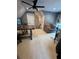 Upstairs bonus room featuring a ceiling fan, sofa, desk, and stairway at 121 N Summit Ave, Lake Helen, FL 32744