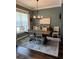 Inviting dining room with a large window, modern chandelier, and stylish decor at 121 N Summit Ave, Lake Helen, FL 32744