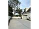 Wide concrete driveway with basketball hoop leading up to a two car garage with adjacent landscaping at 121 N Summit Ave, Lake Helen, FL 32744
