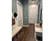 Hallway features a bench with storage, a side table, and neutral tones at 121 N Summit Ave, Lake Helen, FL 32744