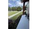 Inviting covered porch with rocking chairs and a view of the landscaped front yard at 121 N Summit Ave, Lake Helen, FL 32744