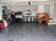 Spacious garage with work area, cabinets, and stairs to an upper level at 121 N Summit Ave, Lake Helen, FL 32744