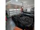 Well-lit garage featuring a sleek black sports car, modern grey car, and functional storage solutions at 121 N Summit Ave, Lake Helen, FL 32744