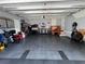 Spacious garage with epoxy flooring, storage cabinets and workbench at 121 N Summit Ave, Lake Helen, FL 32744