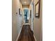 Hallway featuring hardwood floors, art, and openings to rooms at 121 N Summit Ave, Lake Helen, FL 32744