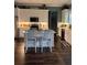 Modern kitchen with white cabinets, stainless steel appliances, and a center island with seating at 121 N Summit Ave, Lake Helen, FL 32744