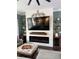 Cozy living room features an electric fireplace, large TV, and stylish decor at 121 N Summit Ave, Lake Helen, FL 32744