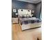 Well-lit bedroom featuring a white wood paneled bed and matching nightstands at 121 N Summit Ave, Lake Helen, FL 32744