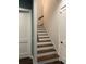 Staircase features dark wood treads and white risers, with modern doors at 121 N Summit Ave, Lake Helen, FL 32744