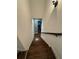 Bright staircase featuring hardwood steps, white risers, and a dark wood handrail at 121 N Summit Ave, Lake Helen, FL 32744