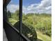 Enjoy tranquil nature preserve views from this screened balcony with black aluminum railings at 1288 Grady Ln, Davenport, FL 33896