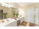 Bathroom featuring a double sink vanity, mirrors, and a glass-enclosed shower at 1288 Grady Ln, Davenport, FL 33896