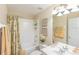 A bright bathroom featuring a tub/shower combination at 1288 Grady Ln, Davenport, FL 33896