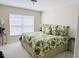 Bright bedroom featuring tropical bedding and window for lots of natural light at 1288 Grady Ln, Davenport, FL 33896