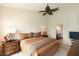 Bedroom featuring warm tones, decorative bedside lamps, and an ensuite bathroom at 1288 Grady Ln, Davenport, FL 33896