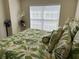 A bright bedroom featuring tropical bedding and window for lots of natural light at 1288 Grady Ln, Davenport, FL 33896