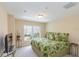 Bright bedroom featuring tropical-themed bedding, neutral walls, and natural light from the window at 1288 Grady Ln, Davenport, FL 33896