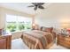 Bright bedroom with leafy ceiling fan, large window, and decorative furnishings at 1288 Grady Ln, Davenport, FL 33896